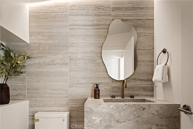 half bath featuring a sink and toilet