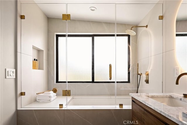 bathroom with tiled shower / bath and vanity