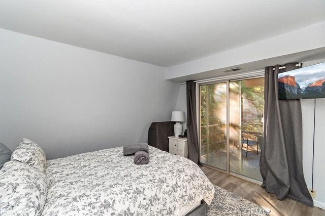 bedroom with visible vents and wood finished floors