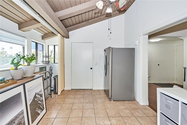 kitchen featuring wooden ceiling, light tile patterned flooring, freestanding refrigerator, a ceiling fan, and vaulted ceiling with beams