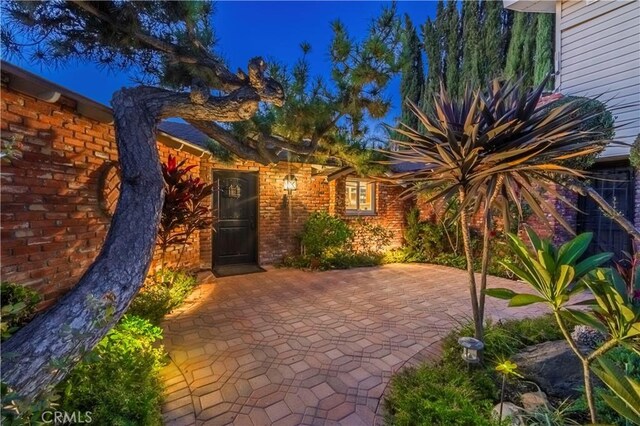 2333 N Coronet Ct, Covina, CA 91724 - doorway to property featuring a patio area and brick siding