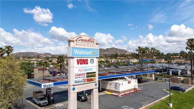 surrounding community with covered and uncovered parking and a mountain view
