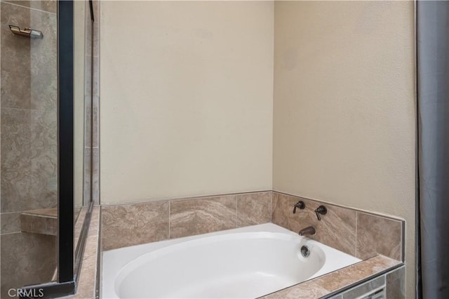 full bath featuring a garden tub and a shower stall