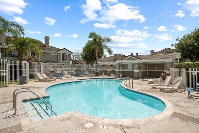 pool featuring fence and a patio