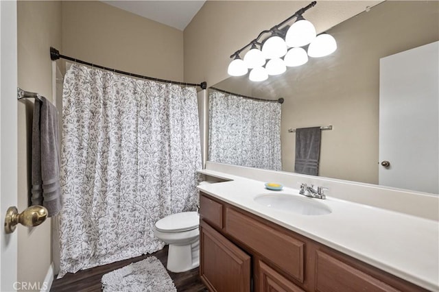 bathroom with a shower with shower curtain, wood finished floors, toilet, and vanity