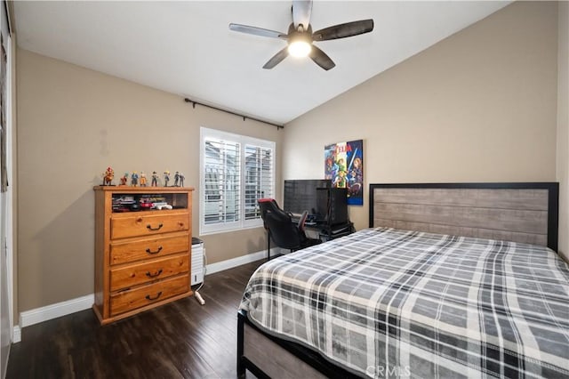 bedroom featuring dark wood-type flooring, lofted ceiling, baseboards, and ceiling fan