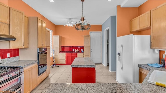 kitchen featuring white fridge with ice dispenser, a center island, ceiling fan, double oven range, and oven