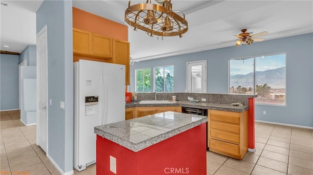 kitchen featuring tile countertops, dishwashing machine, white refrigerator with ice dispenser, a kitchen island, and a sink