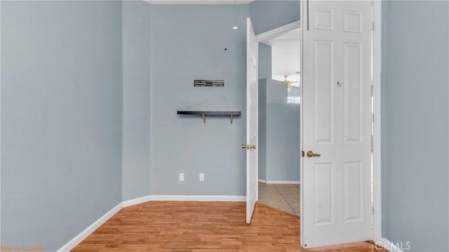 unfurnished bedroom featuring light wood finished floors and baseboards