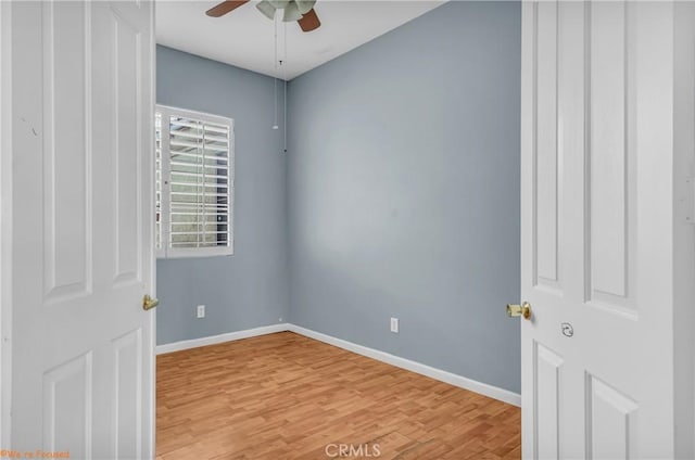 unfurnished room with light wood-type flooring, ceiling fan, and baseboards