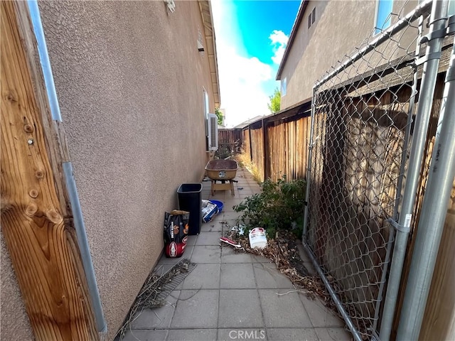view of property exterior featuring stucco siding and fence