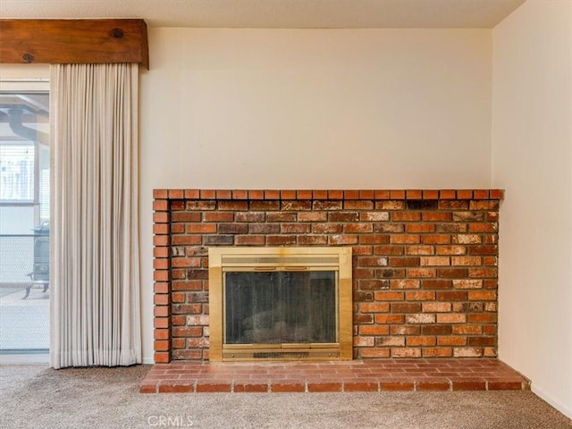 room details featuring carpet flooring and a brick fireplace