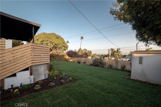 view of yard featuring an outbuilding and fence