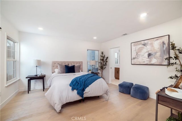 bedroom with ensuite bathroom, baseboards, light wood-style flooring, and recessed lighting
