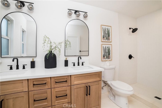 full bath featuring toilet, a sink, double vanity, and a tile shower