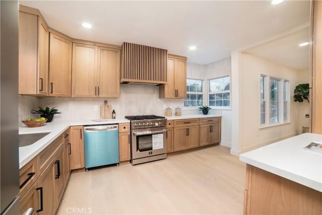 kitchen featuring custom range hood, light countertops, tasteful backsplash, and appliances with stainless steel finishes