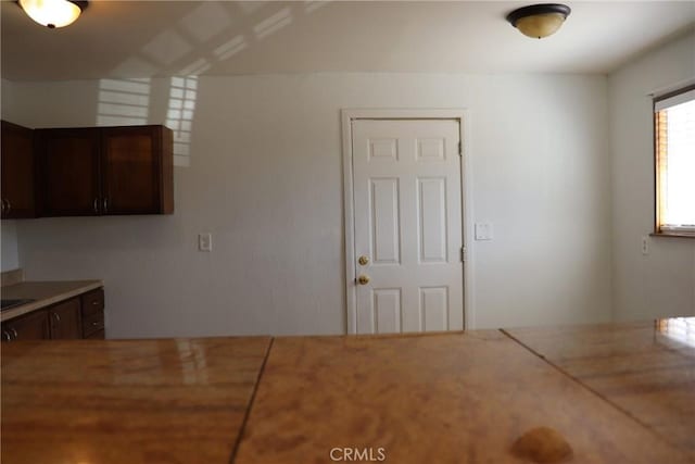 16226 Pine St, Hesperia, CA 92345 - kitchen with light countertops and dark brown cabinetry