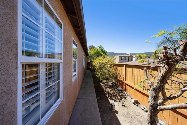 391 Camino Carta, San Marcos, CA 92078 - view of side of home featuring stucco siding and fence