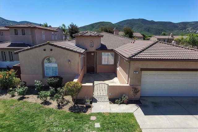 391 Camino Carta, San Marcos, CA 92078 - mediterranean / spanish-style house with a mountain view, stucco siding, a fenced front yard, and a tile roof