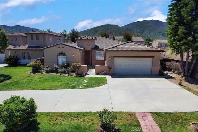 391 Camino Carta, San Marcos, CA 92078 - mediterranean / spanish house featuring stucco siding, a mountain view, a garage, and a tile roof