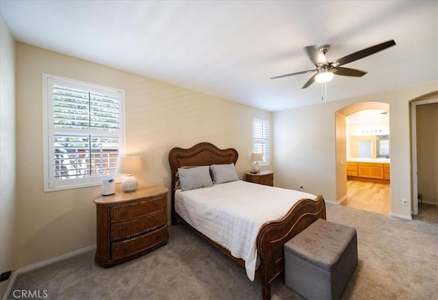 391 Camino Carta, San Marcos, CA 92078 - carpeted bedroom with arched walkways, baseboards, a ceiling fan, and connected bathroom