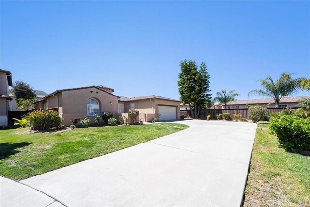 391 Camino Carta, San Marcos, CA 92078 - view of front of property featuring concrete driveway, stucco siding, an attached garage, a front lawn, and fence