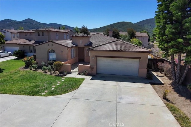 391 Camino Carta, San Marcos, CA 92078 - mediterranean / spanish home with a mountain view, a garage, fence, concrete driveway, and stucco siding