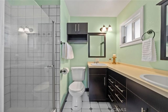 full bathroom with double vanity, tile patterned floors, toilet, and a shower stall