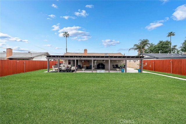 back of house with a yard, a patio, and a fenced backyard