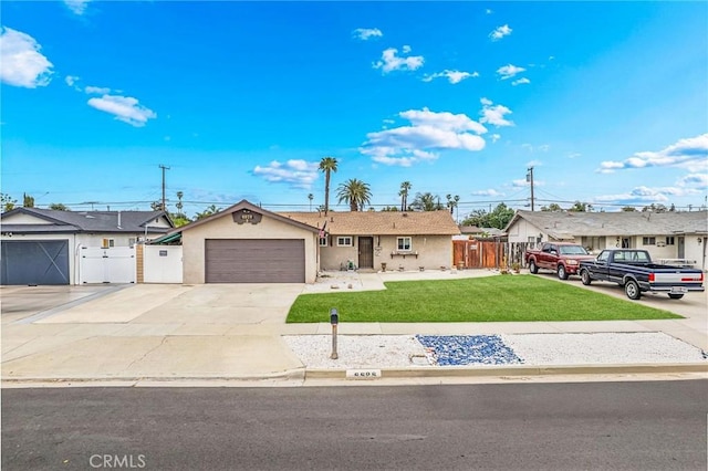 ranch-style house with a gate, stucco siding, concrete driveway, and a front yard