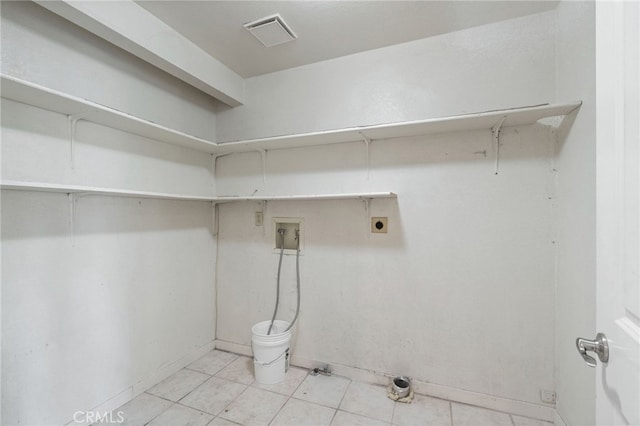 clothes washing area featuring hookup for an electric dryer, visible vents, baseboards, washer hookup, and laundry area