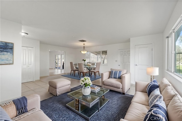 living area featuring visible vents and light tile patterned floors