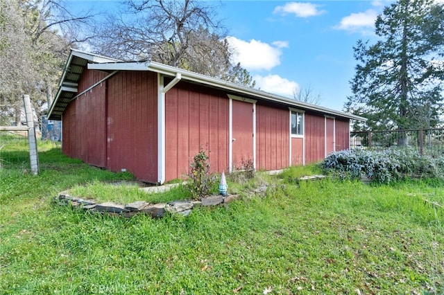 view of outbuilding with an outbuilding and fence