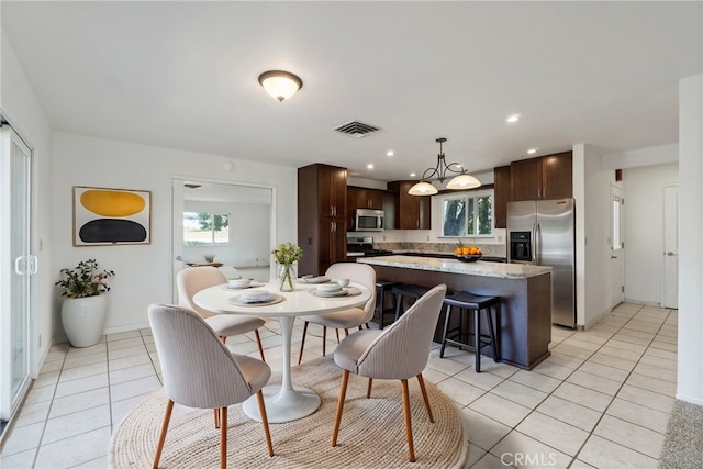 dining space featuring baseboards, visible vents, recessed lighting, and light tile patterned flooring
