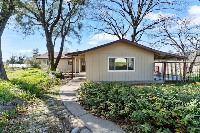 single story home featuring fence