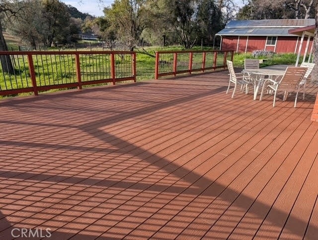 wooden deck featuring outdoor dining area