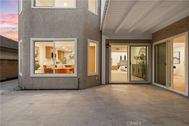 24812 Elena Dr, Laguna Hills, CA 92653 - back of house at dusk featuring a patio area and stucco siding