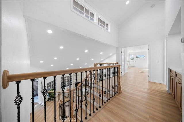 24812 Elena Dr, Laguna Hills, CA 92653 - corridor with an upstairs landing, light wood-style floors, recessed lighting, healthy amount of natural light, and high vaulted ceiling