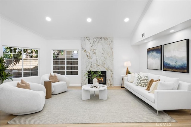 living area featuring visible vents, recessed lighting, wood finished floors, and a fireplace
