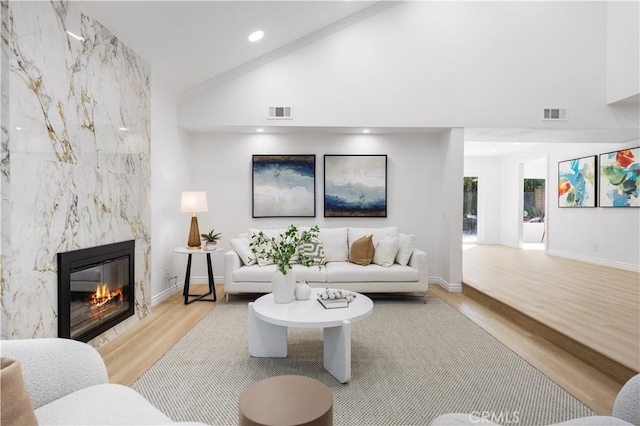 24812 Elena Dr, Laguna Hills, CA 92653 - living area with light wood-style flooring, a premium fireplace, high vaulted ceiling, recessed lighting, and baseboards