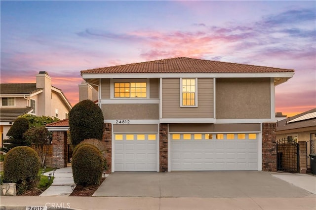 24812 Elena Dr, Laguna Hills, CA 92653 - view of front of home featuring a garage, concrete driveway, a tiled roof, stucco siding, and fence