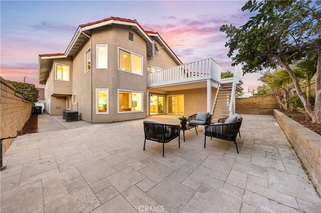 24812 Elena Dr, Laguna Hills, CA 92653 - back of property at dusk featuring a patio area, stairway, and central AC unit