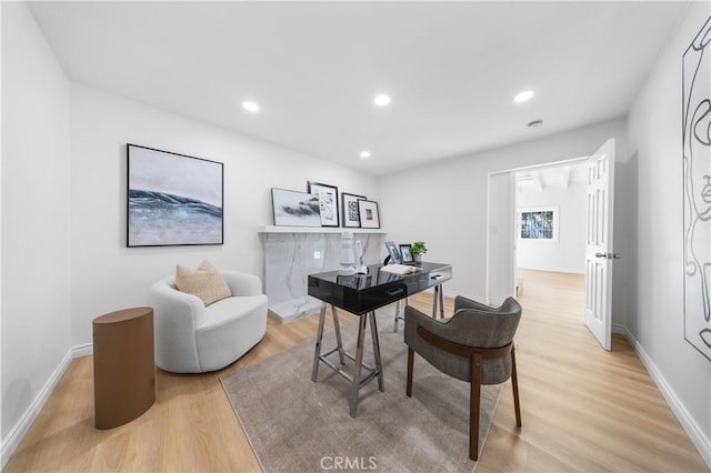 home office featuring baseboards, recessed lighting, and light wood-style flooring