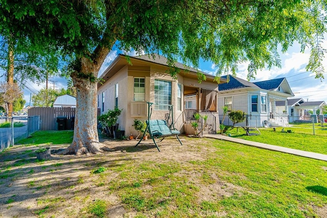 view of front of home featuring fence private yard and a front yard