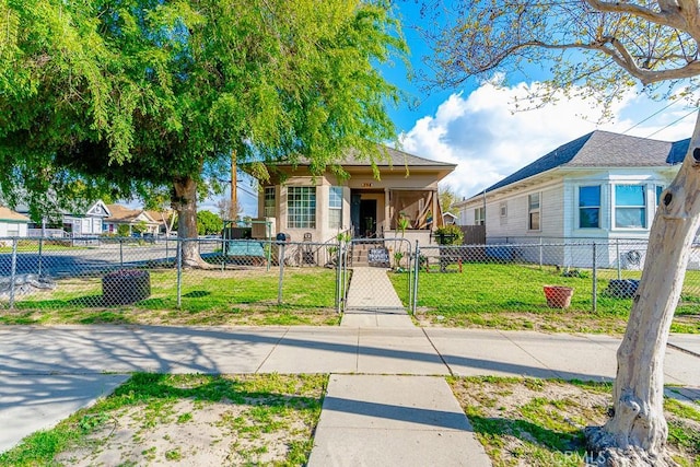 view of front of house featuring a gate, a fenced front yard, and a front lawn
