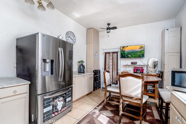 kitchen featuring a ceiling fan, light tile patterned floors, and stainless steel refrigerator with ice dispenser