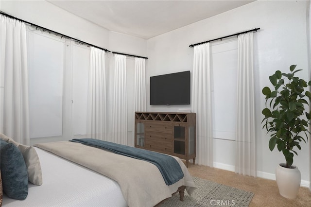 bedroom with baseboards and carpet floors