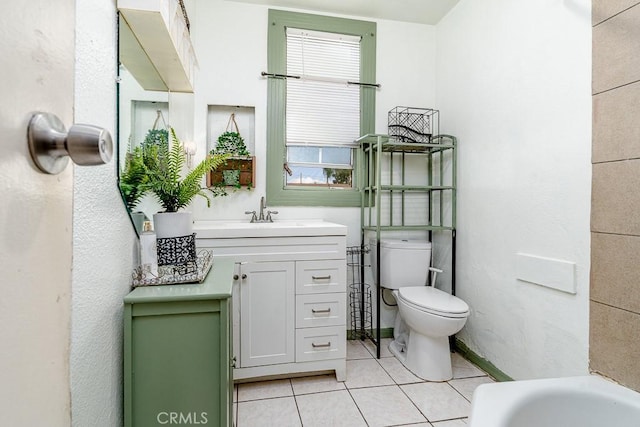 bathroom with tile patterned floors, vanity, and toilet