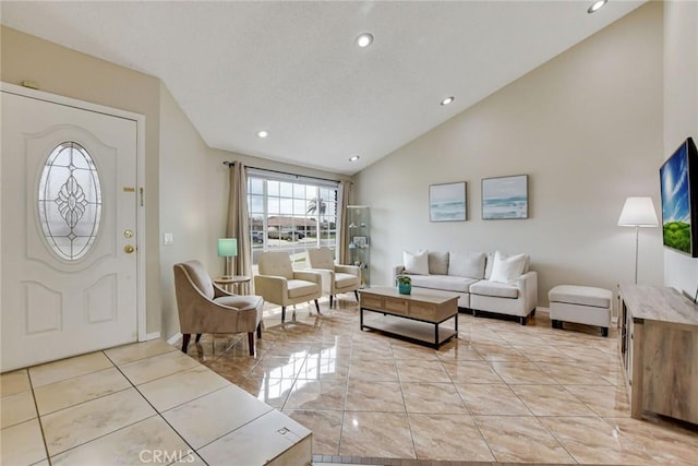 living room featuring baseboards, lofted ceiling, and recessed lighting