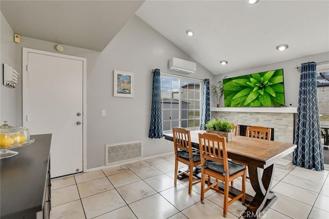 dining space with a wall mounted AC, visible vents, vaulted ceiling, and light tile patterned floors
